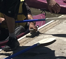 hand holding cleat on boat dock