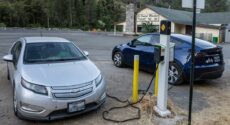 EV charging station with grocery store behind it