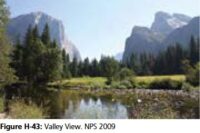 river in foreground, mountains behind