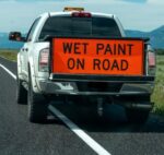 sign says wet paint on road